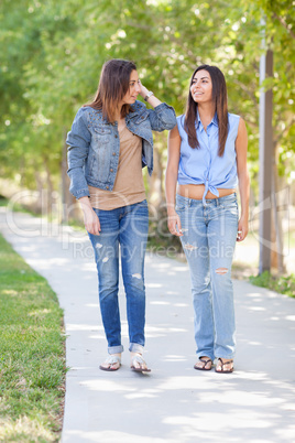 Two Beautiful Ethnic Twin Sisters Walking Outdoors.