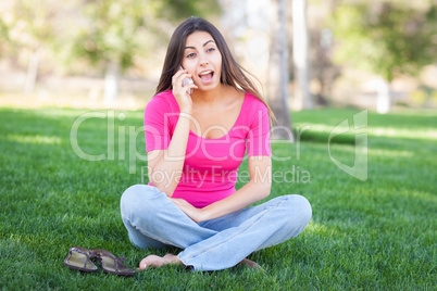 Beautiful Young Ethnic Woman Talking on Her Smartphone Outside.