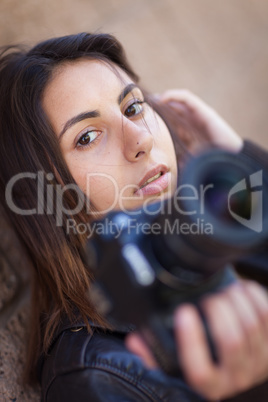 Young Adult Ethnic Female Photographer Against Wall Holding Came