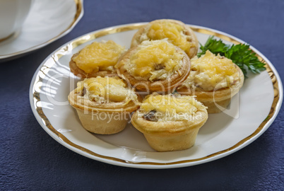 Tartlets with cheese and a Cup of coffee.