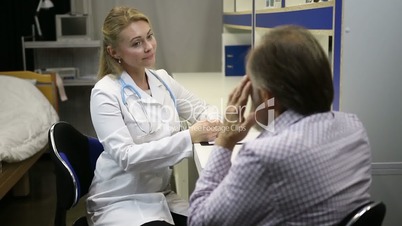 Female doctor asking senior patient for symptoms
