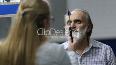 Senior man examined by female neurologist in clinic