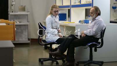 Doctor checking knee reflexes of the patient