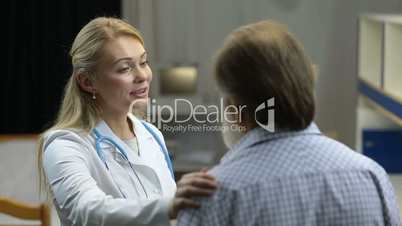 Friendly female doctor encouraging ill patient