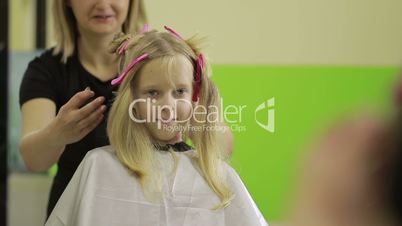 Portrait of cute little girl in hairdressing salon