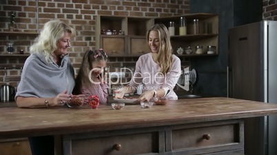 Joyful family awaiting to taste cookies in kitchen