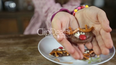Child's hands offering delicious homemade cookie