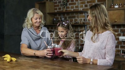Cheering family with mason jars of smoothie