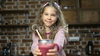 Smiling little girl offering tasty fresh smoothie