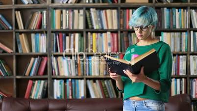 Smart looking female student reading in library