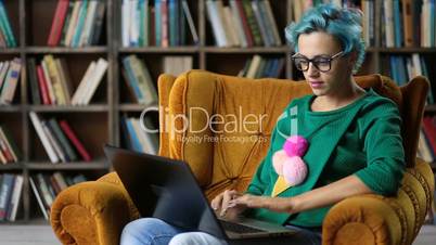Contemplating female freelancer working on laptop