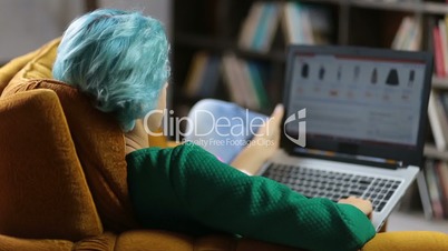 Charming female hipster browsing shopping website.