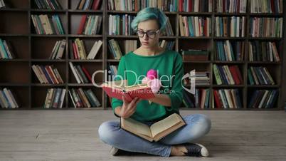 Young woman in glasses reading an interesting book