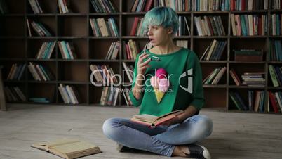 Thoughtful young woman enjoying reading a book