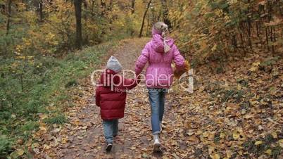 Carefree siblings running in autumn park