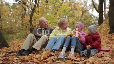 Happy family spending leisure in autumn park