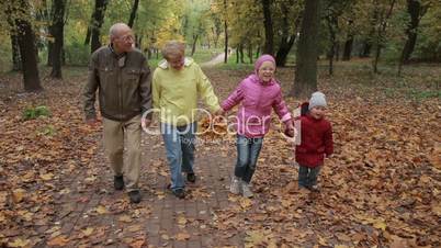 Elderly couple and grandchildren together in autumn