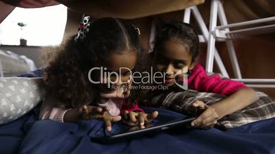 Smiling african american girls using tablet pc