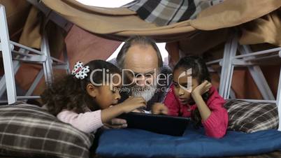 Clever kids showimg grandpa how to use touchpad