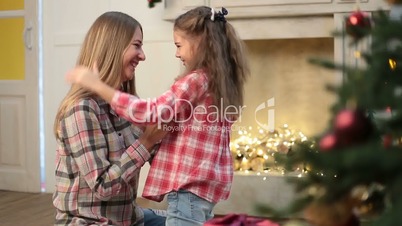 Mother and daughter hugging at Christmas at home