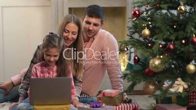Christmas family chatting on internet with laptop