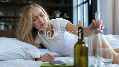 Boozy young woman waking up in bed after party