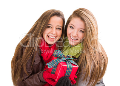 Mixed Race Young Adult Females Holding A Christmas Gift Isolated
