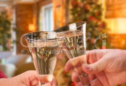 Man and Woman Toasting Champagne in Front of Decor and Lights.