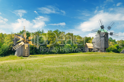 old wooden windmills in a field