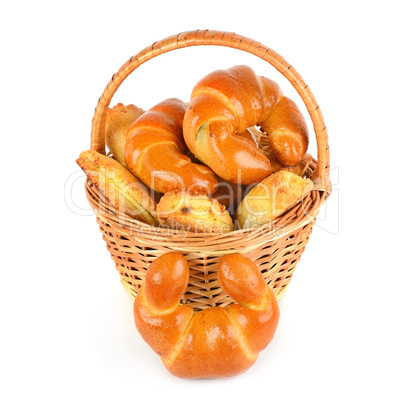 Croissants and cottage cheese rolls in wicker basket isolated on
