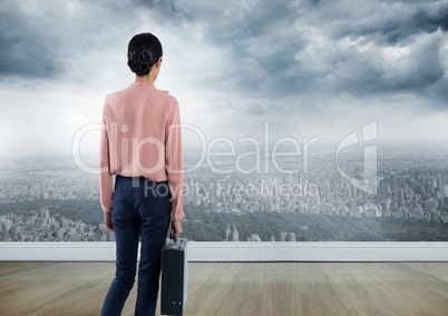 Businesswoman with briefcase over city