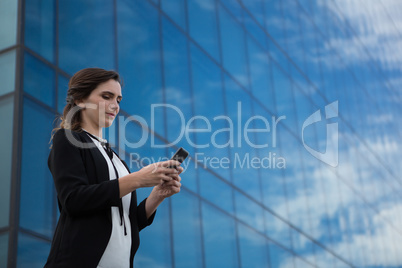 Female executive using mobile phone