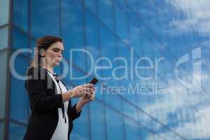Female executive using mobile phone