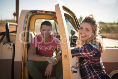 Couple interacting with each other near a car