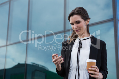 Female executive using glass sheet