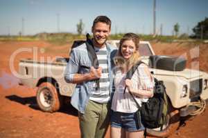 Couple standing together with backpack on a sunny day