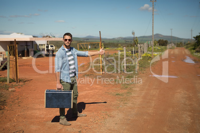 Man hitchhiking on a sunny day