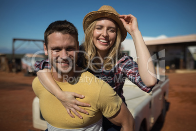 Man giving a piggyback ride to woman