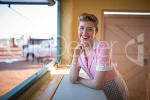 Waitress standing at counter in restaurant