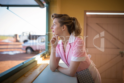 Waitress standing at counter in restaurant