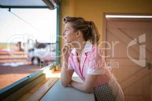 Waitress standing at counter in restaurant