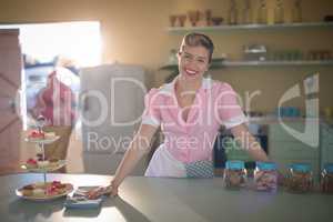 Waitress standing at counter in restaurant