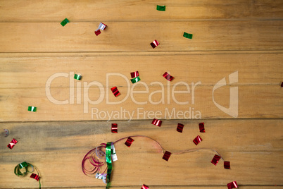Confetti and streamers on wooden surface