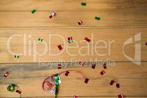 Confetti and streamers on wooden surface