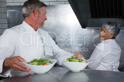 Male chef holding food plate