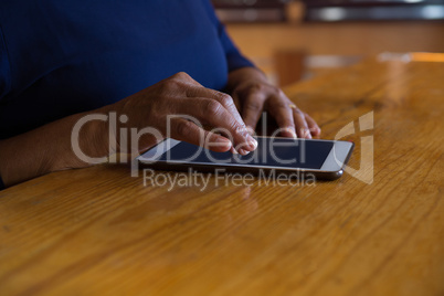 Waitress using digital tablet in cafe