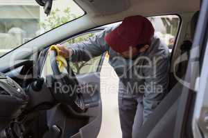 Auto service staff cleaning car interior