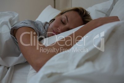 Woman sleeping peacefully on bed