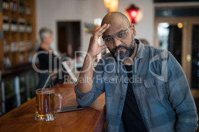 Depressed man sitting at counter