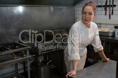 Female chef standing in the kitchen